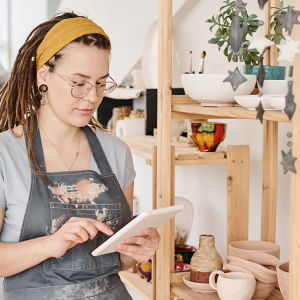 Small business owner shown using a tablet.