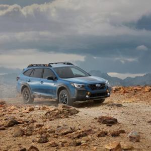 A car driving along a dirt track 