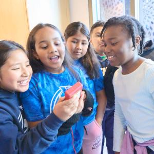 Students looking at a device
