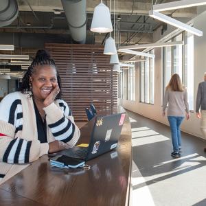 Benita Harrington sat at a table with their laptop