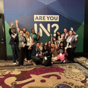 People posing in front of a Disability:IN Conference back drop 