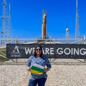 Joan Melendez Misner in front of rocket