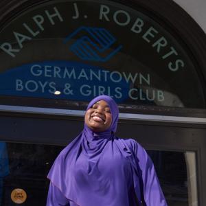 person smiling in font of the Boys and Girls Club