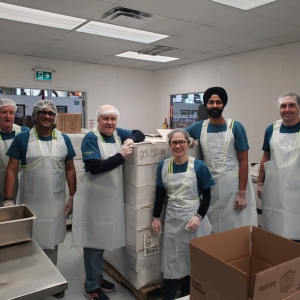 Group wearing aprons and smiling together