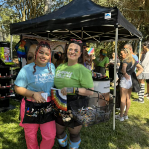People standing together outside next to a tent