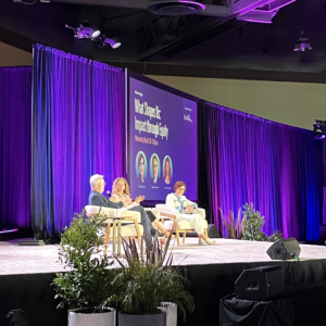 People sat on stage in front of an audience at the 2024 WELL Conference