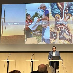 Person on stage beneath large screen