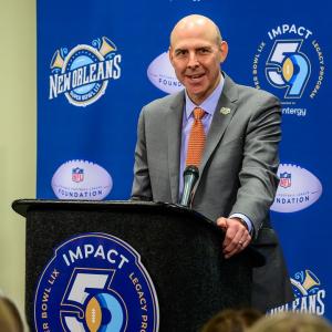 Person in a suit talking behind a podium