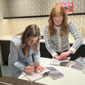 Columbia Law School professor Alexandra Carter and her daughter Caroline Carter Lembrich sign books