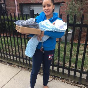 Person holding baby and computer box