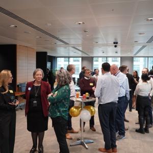 A group of people stood inside an office attending the ACE celebration 2024 event