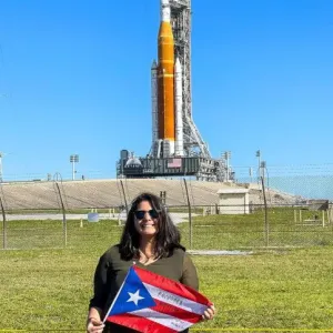 Joan Melendez Misner in front of rocket