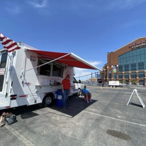 Two people outside a FedEx canteen truck