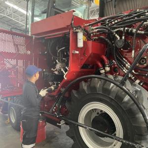 A person walking on agricultural machinery 