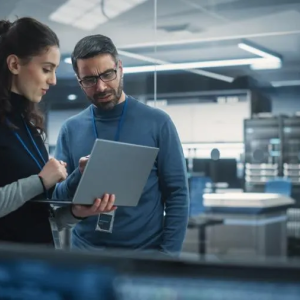Two people looking at a laptop