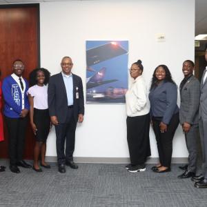 People stood either side of a FedEx poster