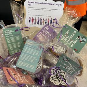 A box of individually wrapped cookies that have labels on providing information on inspirational women from around the world 