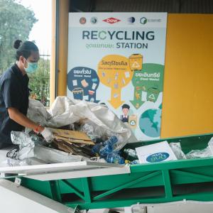 A person sorting through recycling 