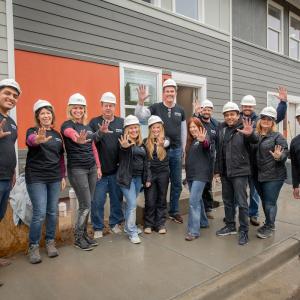 Arrow employees pose for a group photo while on the Habitat for Humanity build site