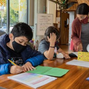 An instructor providing guidance to students at 826 Valencia. Photo by Malcolm Eaton