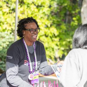 people speaking to each other at a booth