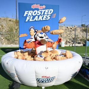 Tony the Tiger standing in inflatable bowl of Frosted Flakes