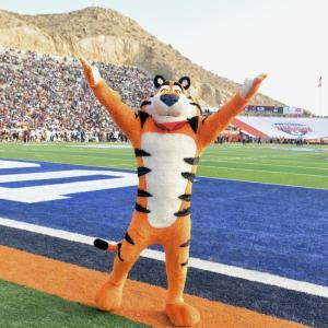 Tony the Tiger stands on football field 