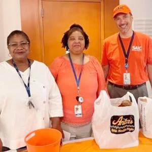 Three people stood together 