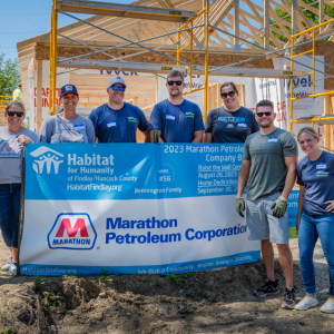 People standing in front of house framing