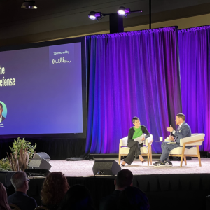 Two people sat on stage talking at the 2024 WELL Conference