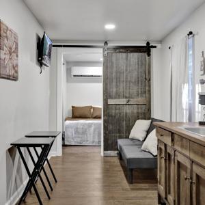 View of kitchen with tables and couch visible behind it