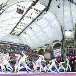 Olympic fencers inside a large building