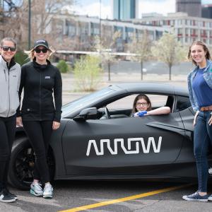 Clemetsen poses with the Helping Hand Glove inside of the SAM car