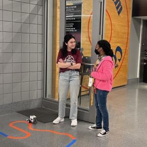 two people standing together talking