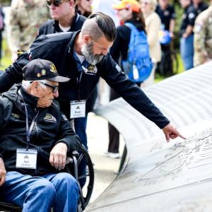 A person pointing to a plaque 