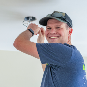 Person installing ceiling light
