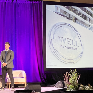 Four people stood on stage at the 2024 WELL Conference