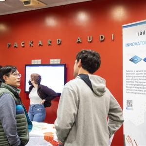 students meeting Cadence employees