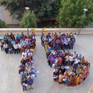 people gathered together to spell out "75"