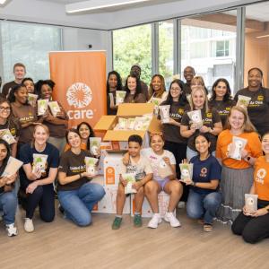 volunteers posing for a group photo with CARE packages
