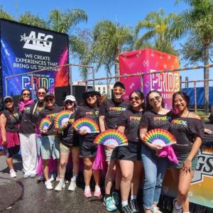 AEG Employees pose in front of Pride float