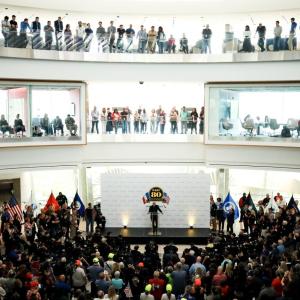A large audience of people surrounding a stage 