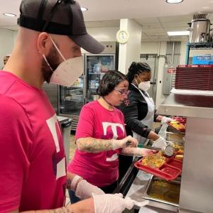 People putting food onto trays