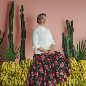 Someone posing amongst cactii and bananas