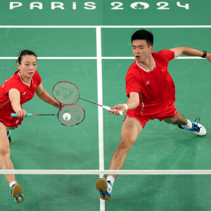 Two Olympians playing badminton