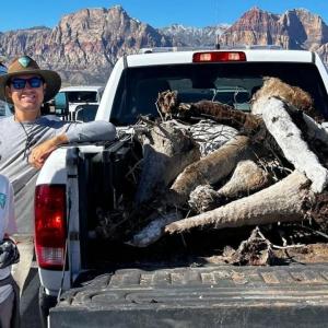 Two people stood near the trunk of a car