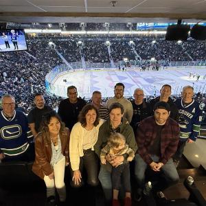 DP World employees and living donors group photo in DP World's suite at the Vancouver Canucks game