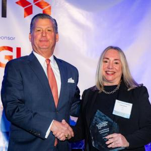 CACI’s Linda Braun, Ph.D. accepting an award