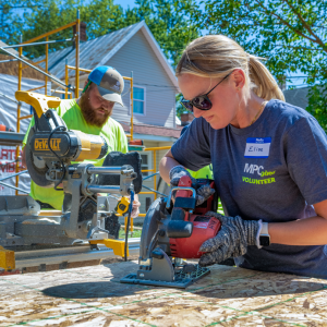People using saws outside