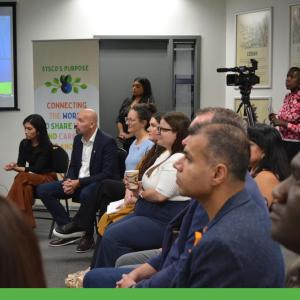 People seated and listening to a presentation